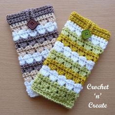 two crocheted cell phone cases sitting on top of a table