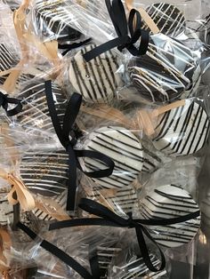 several zebra print cookies wrapped in plastic and tied with black ribbon on top of each other