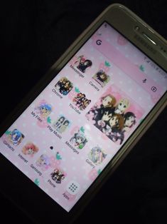 a cell phone with some stickers on it's screen and an anime theme