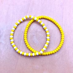 Ullabeads Yellow Bead Bracelet Set | Yellow Bead Bracelet Stack | Yellow Anklet ⚠️NOTE: Please do NOT guess wrist size! Always measure your wrist :) ❤️ 🟡⚪️🟡⚪️🟡⚪️🟡⚪️ The color yellow is associated with sunny days, joy, happiness, and optimism. These stretchy yellow bracelets are great for summer and make a bold statement! Pair this set with your favorite outfit or footwear. Add these bracelets to your collection today! ☀️ 📌OPTIONS A) Yellow Bracelet  B) Yellow and White Bracelet  C) Set of b Yellow Bracelet With Round Wooden Beads, Yellow Wooden Bead Bracelets, Yellow Wooden Beads Bracelet, Adjustable Yellow Wooden Beaded Bracelets, Yellow Bracelet Beads, Yellow Friendship Bracelet, Yellow Beaded Bracelets, Yellow Bead Bracelet, Bead Bracelet Stack