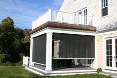 a house with an enclosed patio and deck