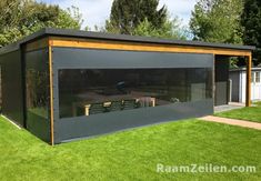 an outdoor dining area in the middle of a yard with grass and trees around it