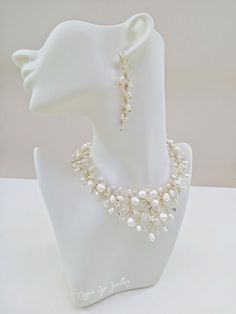 A truly beautiful bridal necklace, handmade with quality ivory freshwater pearls and the finest quality genuine crystals on a champagne gold plated wire showing intricate detailing. The manequin is small so please note the dimensions. The length is around 40cm with an extension chain to lengthen if you please. The drop on the necklace at its widest point is around 3.5 cm. All of our items are made to order so adjustments can be made with regards to materials and designs. Please message us if you require different specifications.  The design is handmade featuring natural cultured freshwater pearls, we always use quality materials however colours, sizes and shapes may vary slightly.  This listing is for the necklace as mentioned above. Please see our other items for the matching accessories Gold Wedding Jewellery, Bridal Necklace Gold, Gold Bridal Jewellery, Bridal Necklace Pearl, Pearl Jewellery Set, Jewellery Set Gold, Gold Pearl Jewelry, Gold Bridal Necklace, Bridal Pearl Necklace