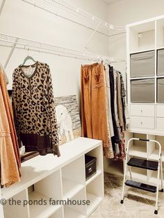 a closet with clothes hanging on shelves and other items in the room next to it