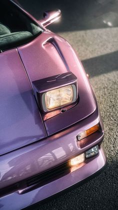 the front end of a purple sports car