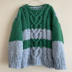 This True Heart Pullover is oversized, long, boxy with straight sleeves. Hand knit with chunky wool, several texture cable knitted heart and braided on the pullover both front and back!  This super cute heavy knit will keep you warm and cozy, super soft touch with pure wool. Comes in Striped sky blue and green color. Size: Width 55 cm /22"           Length 65 cm/26"           Fit to chest approx 100 cm/40" Fit for S/M,L P.s. Model is 5'3 / 104 lbs. I am happy to knit custom sweater if you would Green Chunky Knit Long Sleeve Knitting Pattern, Green Long Sleeve Chunky Knit Pattern, Cozy Chunky Long Sleeve Sweater, Oversized Green Chunky Knit Sweater, True Heart, Love Sweater, Custom Sweaters, Knitted Heart, Sweater Chunky