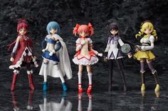 five anime figurines are lined up on a black surface