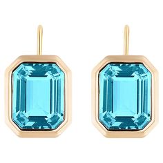 These Blue Topaz Emerald Cut Bezel Set Earrings on Wire in 18K Yellow Gold from the 'Manhattan Collection are a stunning and sophisticated jewelry piece. These earrings feature exquisite blue Topaz gemstones with an elegant emerald cut, cradled in a secure bezel setting made of luxurious 18K yellow gold. The design exudes a modern, chic style, making them a perfect choice for adding a touch of glamour to any outfit. These earrings are a true representation of the Manhattan Collection's fine craf Spring Tones, Bezel Set Earrings, Sophisticated Jewelry, Set Earrings, Wire Earrings, Modern Chic, Topaz Gemstone, Bezel Setting, Emerald Cut