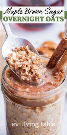 an oatmeal in a glass jar with spoon and cinnamon on top