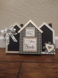 a black and white house with a bow on it's head sitting on top of a wooden table