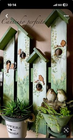 some birds are perched on top of bird houses