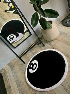 a black and white area rug with the number eight on it next to a mirror