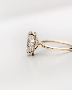 a gold ring with a white diamond on it