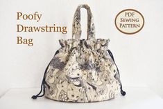 an image of a handbag with the words poofy drawstring bag on it