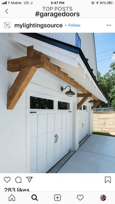 an instagramted photo of a house with two white garage doors on the side