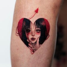 a woman's heart shaped tattoo with a girl holding her hand to her face