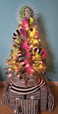 a brightly colored christmas tree with presents under it