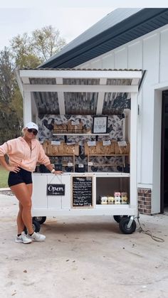 a woman standing in front of a food truck with her hands on the back of it