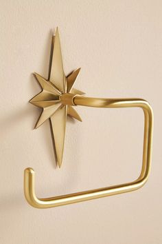 a gold metal towel ring with a star on it