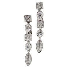 Here we have an elegant pair of drop earrings from the world renowned luxury Italian jewellery house of Bvlgari. Beautifully crafted from 18ct white gold, these dangling earrings form part of the Lucea collection and showcase an alternating array of motifs including square, round and pear shaped settings intended to evoke the feelings of freedom we associate with nature. Each piece is filled with high quality bright white round brilliant cut diamonds. A timeless pair of earrings offering modern Bulgari Earring, Bulgari Jewelry, Italian Jewelry, Les Sentiments, Diamond Drops, Dangling Earrings, Round Brilliant Cut Diamond, Long Earrings, Pear Shaped