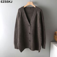 Brand Name: EzsskjStyle: High StreetThickness: STANDARDHooded: NoMaterial: CottonMaterial: PolyesterOrigin: CN(Origin)Season: Spring/AutumnPattern Type: SolidClothing Length: LongType: RegularGender: WOMENAge: Ages 18-35 Years OldCollar: V-NeckClosure Type: Single BreastedItem Type: Outerwear CoatsSleeve Length(cm): FullSleeve Style: RegularRelease Date: FW2021Outerwear Type: JacketsDecoration: ButtonDecoration: NONE Solid Color V-neck Cardigan For Layering, Oversized V-neck Sweater Coat For Fall, Trendy Solid Color V-neck Cardigan, Trendy V-neck Solid Color Cardigan, Elegant V-neck Knitted Cardigan, Gray Knitted V-neck Outerwear, Casual Solid Color V-neck Sweater For Winter, Knit V-neck Sweater Coat For Winter, V-neck Knit Sweater Coat For Fall