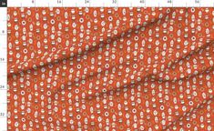 an orange fabric with white circles and dots on it, as well as the measurements