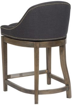 an upholstered bar stool with black fabric and gold trimmings on the back