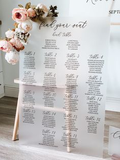 a table plan with flowers on it and the seating card in front of it for a wedding ceremony