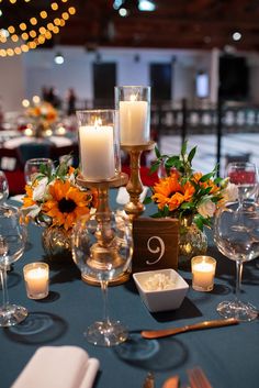 the table is set with candles, plates and silverware for an elegant wedding reception