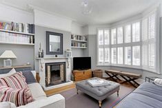 a living room filled with furniture and a fire place