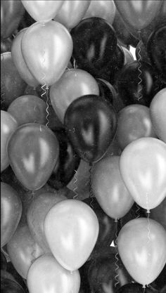 black and white photograph of many balloons