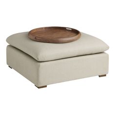 a wooden tray sitting on top of a ottoman