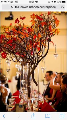 a tall vase filled with lots of wine glasses sitting on top of a table