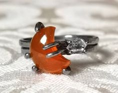 "This gorgeous moon and star ring set is the perfect gift for the boho-hippie spirit! The luminous orange carnelian is carved in a smoothly curving crescent. The tiny glittering Herkimer diamond quartz crystal is set horizontally, positioned to sit perfectly in the inner curve of the moon. Both gems are set in claw settings made in your choice of bright or oxidized sterling silver, rose gold fill, or yellow gold fill. The bands have a hammered texture, giving the metal a silky finish that beauti Unique Orange Ring Jewelry, Bohemian Orange Jewelry Ring, Handmade Bohemian Orange Ring, Orange Moonstone Ring Gift, Bohemian Orange Rings For Gifts, Crescent Moon And Star, Herkimer Diamond Ring, Celestial Ring, Raw Crystal Ring