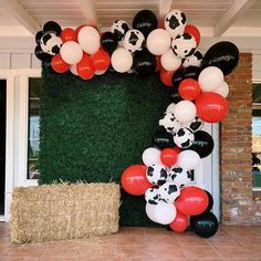 the balloon wall is decorated with black, white and red balloons