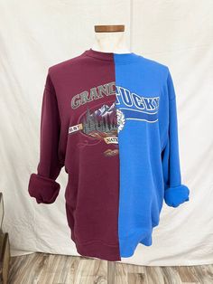 Half and half blue and burgundy sweatshirt. Size M/L Fall Graphic Print Sweatshirt For Layering, Purple Graphic Print Sweater For Fall, Burgundy Crew Neck Top For Layering, Purple Winter Tops For College, Purple Winter College Tops, Blue Varsity Sweater For Fall, Purple Graphic Print Sweatshirt For Fall, Purple Tops For College In Fall, Blue And Burgundy