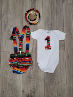 The perfect mexican serape outfit for your little one. All sold separately. Diaper cover includes the bow tie and suspenders. Huaraches are not included but you can buy at our shop also. No returns accepted. Ready to ship in 1 day. You can always exchange it for a bigger or smaller size. (Buyer is responsible for both shipping costs if an exchange is necessary) Please let me know if you have questions about the product, I'll be more than happy to help you :) I do not accept returns, but contact Fitted Sets For Birthday And Summer, Fitted Sets For Birthday In Summer, Fitted Sets For Summer Birthday, First Fiesta Birthday, First Fiesta, Mexican Sandals Huaraches, Tie And Suspenders, Mexican Babies, Mexican Sandals