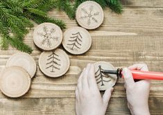 someone is carving christmas tree ornaments on wood