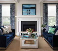 a living room with two couches and a coffee table in front of a fireplace