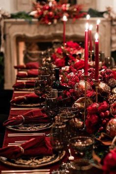 a table set for christmas dinner with red and gold decorations