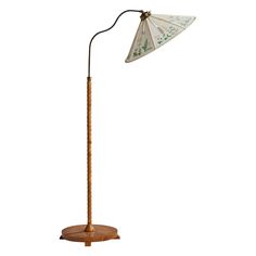 a wooden floor lamp with a white umbrella shade on it's top and base