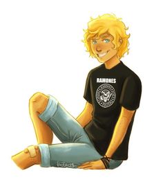 a man with blonde hair sitting on the ground wearing jeans and a t - shirt