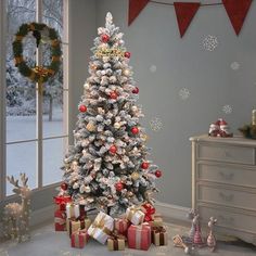 a decorated christmas tree with presents in front of it