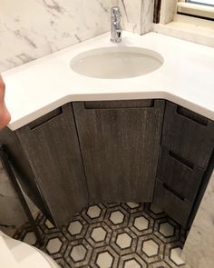 a white toilet sitting next to a bathroom sink