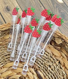 strawberries in plastic cups sitting on top of a basket