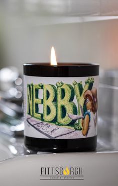 a candle that is sitting on top of a table with the name nebby