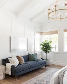 a living room with white walls and wood floors