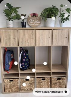 a wooden shelf with baskets and plants on top