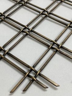 These Flat-wire mesh creates an all-purpose weave that will accommodate any application. Improve or create kitchen cabinets, hutches, curios and other furniture or project. Can be used both indoors and outdoors. These architectural meshes have a beautiful antique brass finish like no other. This unique wire flat top pattern adds visual texture and interest wherever it is used. The wires are crimped in such a way to create facets that collect and redirect light from all angles to allow the mesh to sparkle in its environment. Each side of the mesh has very different textures and either side can be showcased in an application. Dimensions Width: 16" Height: 41.5" Opening of mesh 1-1/4" Wire Size: .072 This item is sold individually (per piece). You can add the quantity you wish to order to you Flat Wire, Woven Furniture, Visual Texture, Knobs And Handles, Wire Mesh, Different Textures, Top Pattern, Brass Finish, Antique Brass