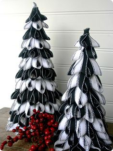 two black and white christmas trees sitting next to each other